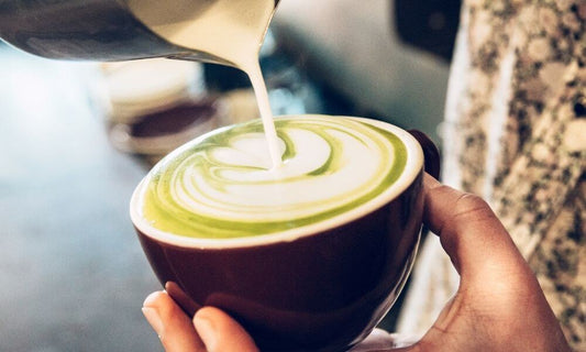 Barista making Superlatte Matcha in a cafe